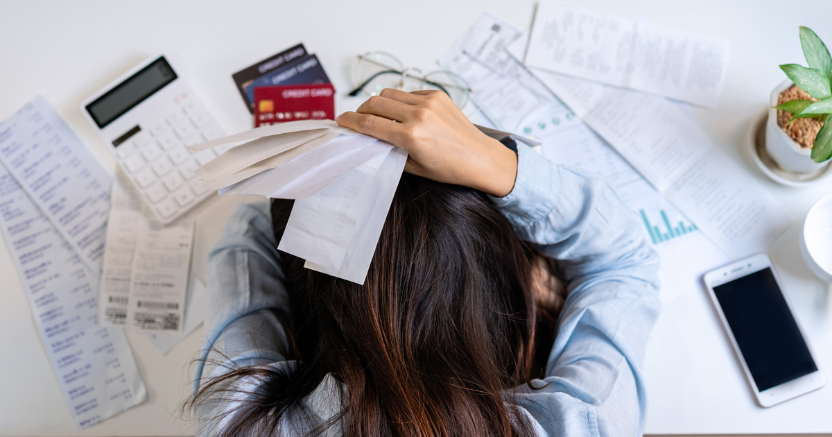 Stressed out person paying bills
