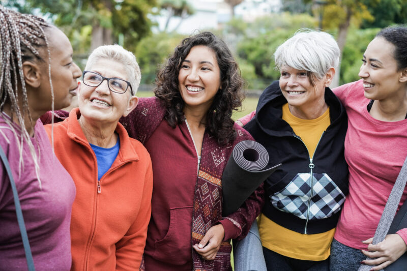Group of Cheerful Women Embracing After Outdoor Exercise